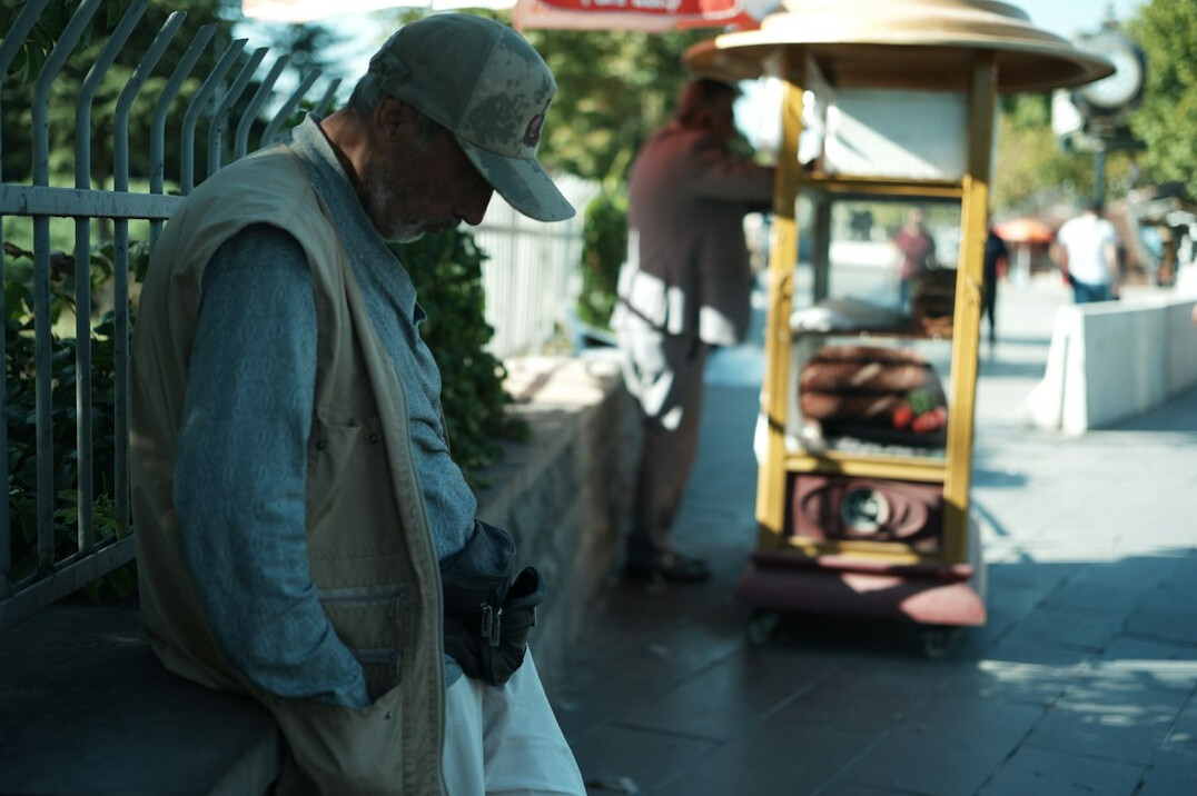 Photographer recording an interview with an elderly man