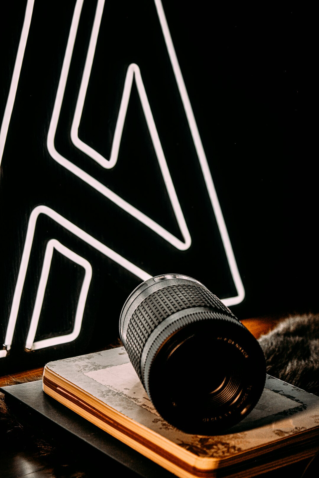 Camera equipment flat lay with lenses and a notebook