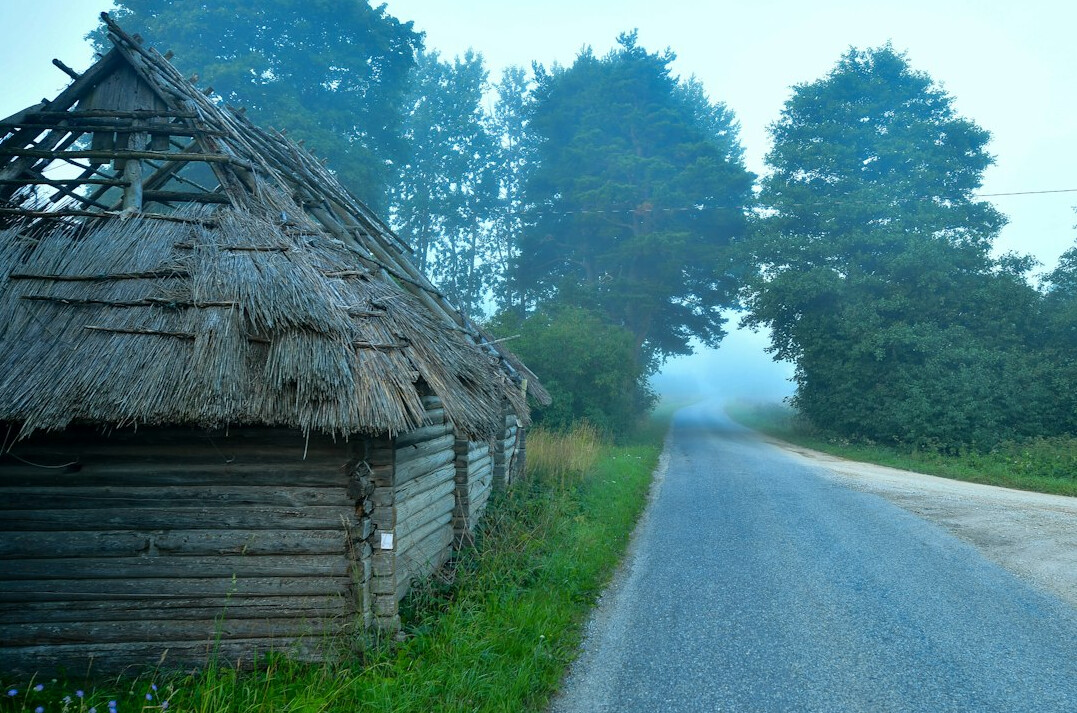 Small Polish village with wooden houses in morning mist