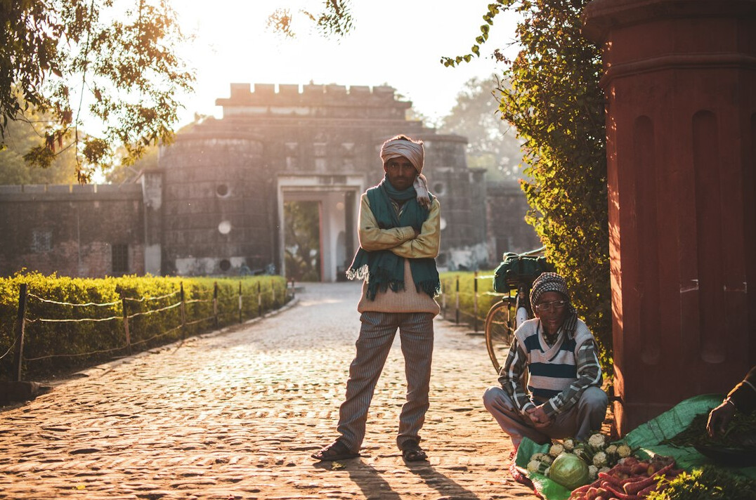 Documentary photographer interviewing an elderly man on a village street