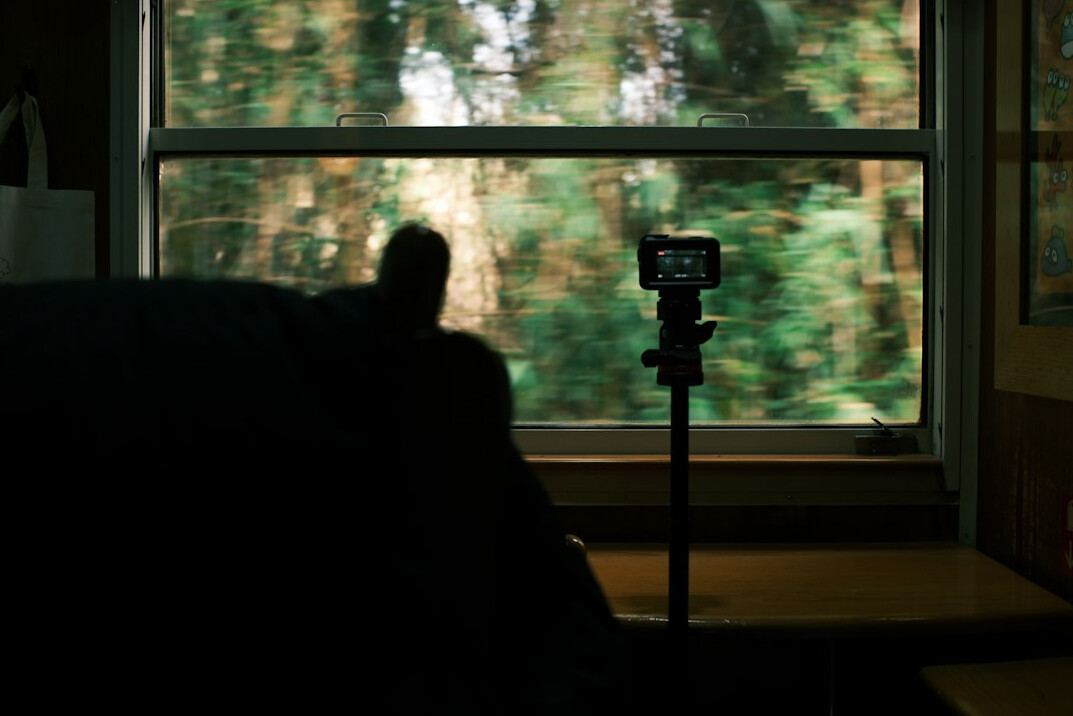 Vintage camera on a tripod near a window